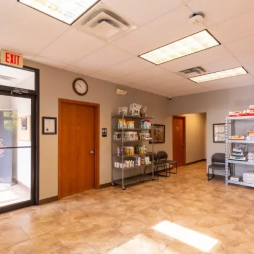 A photo of The welcoming lobby and waiting area at Dunes Animal Hospital, which has shelves stocked with animal food.